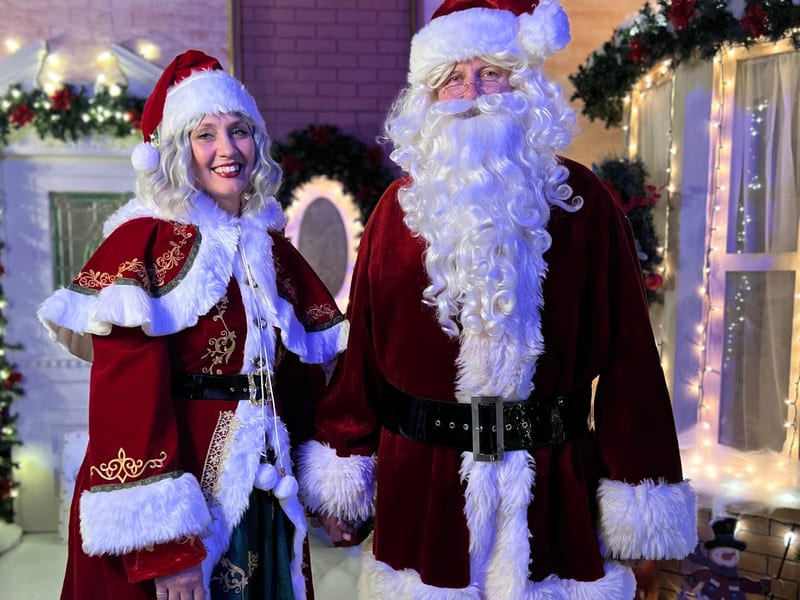 Santa and Mrs. Claus posing at Magic of Christmas